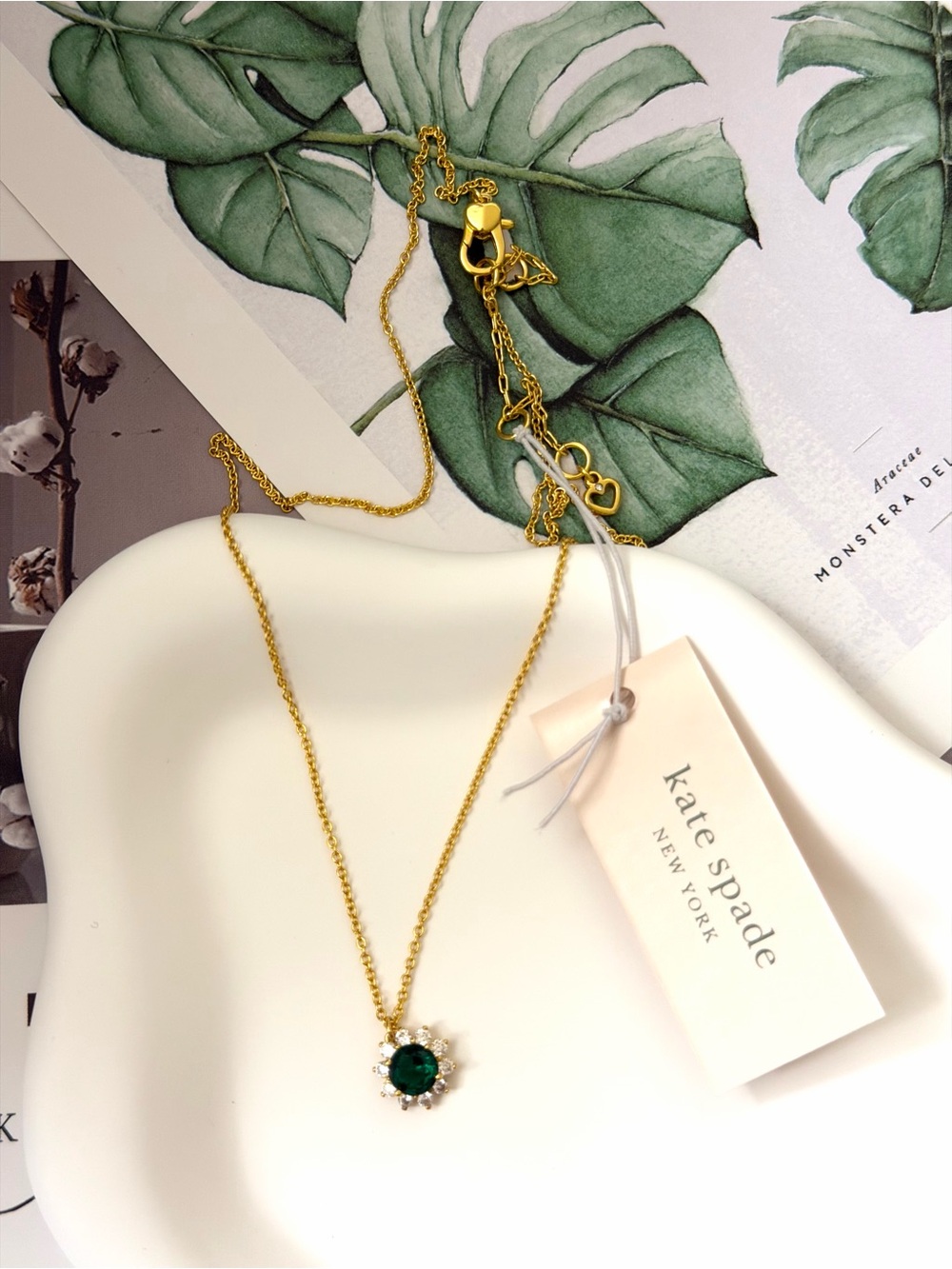 kate spade gold necklace with emerald green stone and halo accents